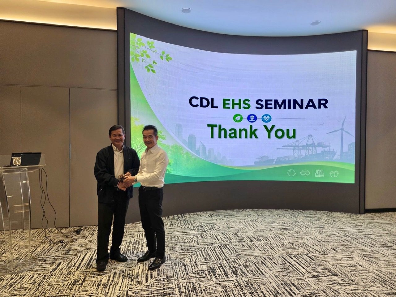Jason Oh receiving a token of thanks in front of the CDL EHS Seminar Thank You screen